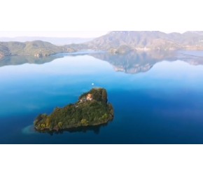 泸沽湖的水太清澈，能看见湖底的鹅卵石。远处的雪顶青山倒映在湖水里，水鸟在湖面悠闲划水，像极了动画里的场景……